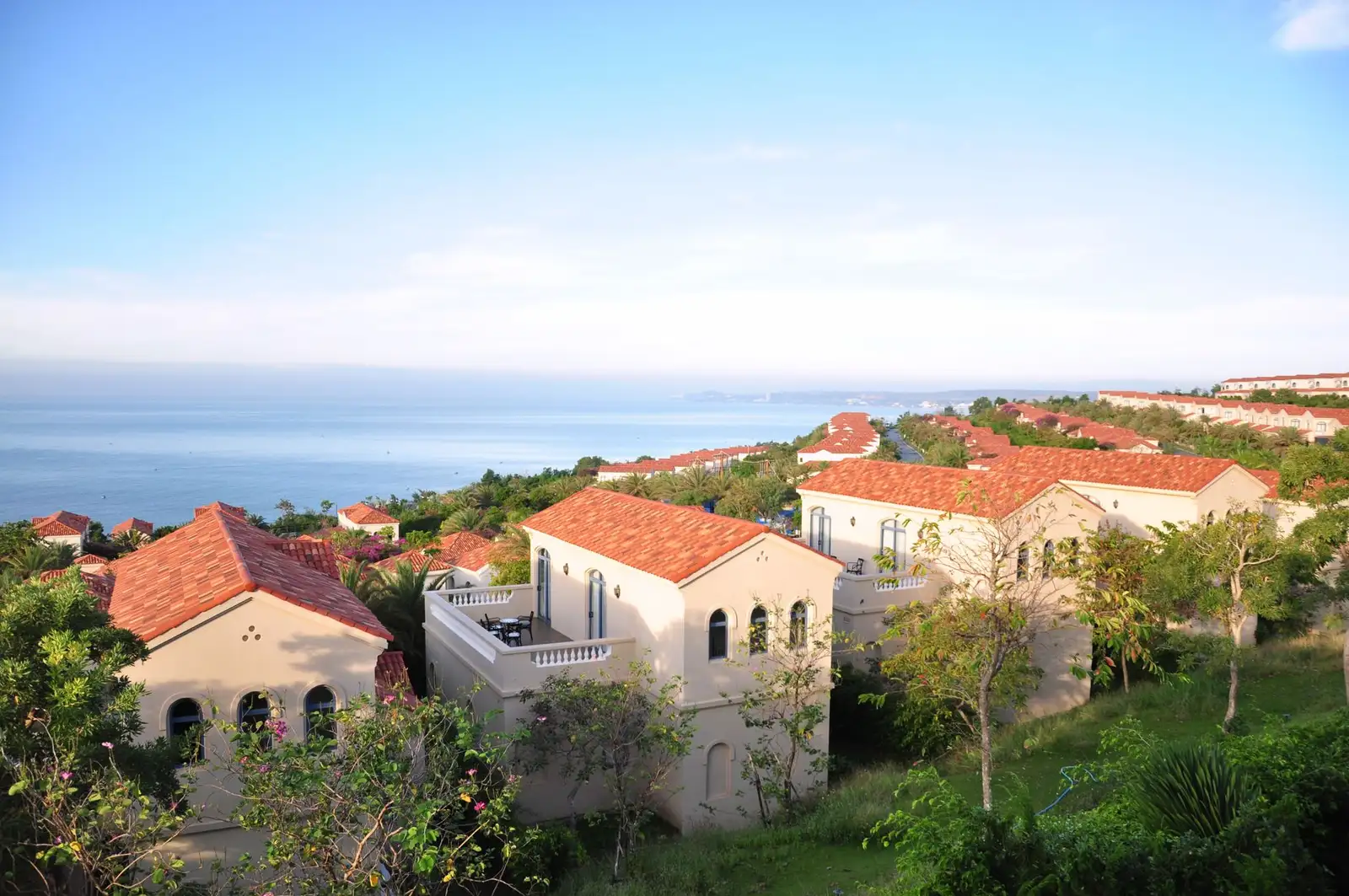 Beautiful Mediterranean villas overlooking a tranquil sea under clear skies.
